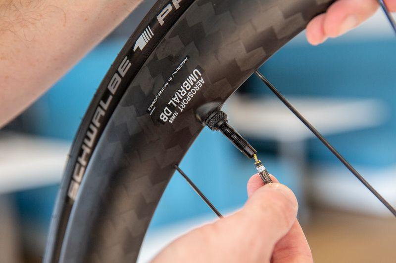 Take the valve core out before you start pumping the tyre for the first time. That way you can pop the tyre in the rim more easily.