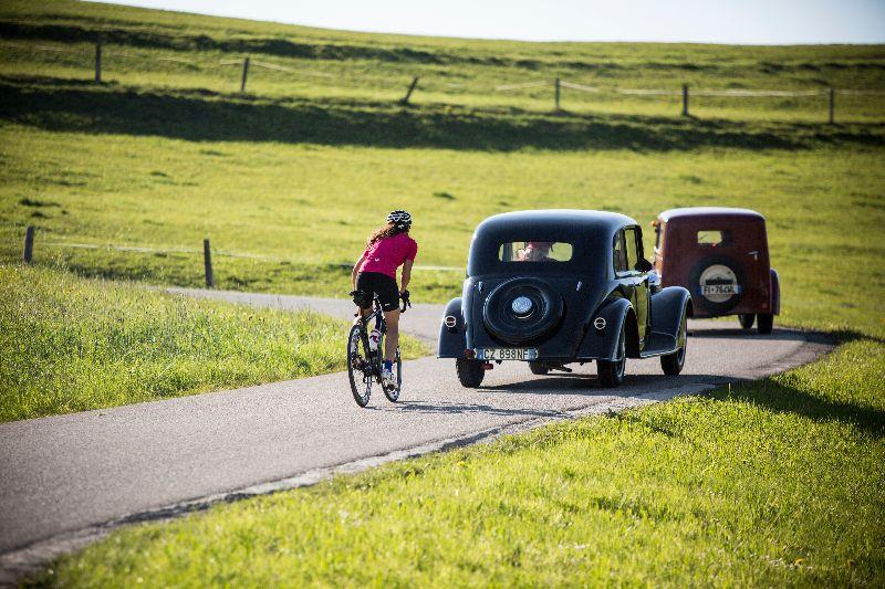 Aerodynamic cycling clothing or would you rather slipstream behind a vintage car? To each their own!